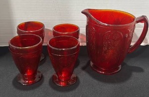 lot 1017 image: Vintage amberina Juice Pitcher with Embossed Flowers Daisies with 4 matching glasses pitcher and one glass has some chips see pictures