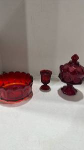 lot 1023 image: Fostoria Ruby Red Coin candy dish with a lid and bowl, and ruby red hobnail candle holder tallest is 9 inches
