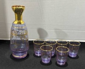 lot 1034 image: Amethyst art glass decanter with gold trim and a Venetian architectural motif with 6 glasses