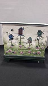 lot 1182 image: Hand-painted wooden chest with 4 drawers featuring a garden motif with birdhouses and pink floral details 13x13x6