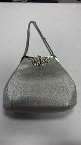 lot 1616 image: Vintage silver metallic evening bag featuring a shimmering glitter finish and an ornate filigree clasp