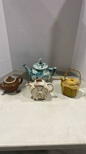 lot 2005 image: Four ceramic teapots