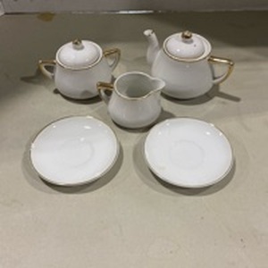 lot 2012 image: White with gold trim childrens tea set, one plate chipped