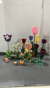 lot 2067 image: Wooden flowers and bunnies with metal tulip candleholders and a plastic tote