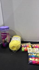 lot 2227 image: Lion Brand bonbons, bernat yarn and yarn trainer