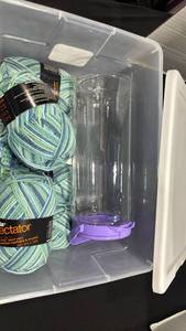 lot 2266 image: Yarn with yarn trainer and Sterilite plastic container