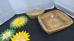 lot 2312 image: Wooden trivets, glass bakeware in wicker holders