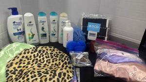 lot 2399 image: Dove shampoo and conditioner, hair ties, shower caps and more