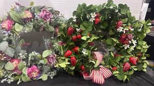 lot 2412 image: Faux floral wreaths one has faux strawberries and stripped ribbon approx 24 inches