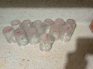 lot 551 image: Lot of 11 Clear Glass Jars with Pink Lids