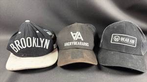 lot 27 image: Lot of 3 Baseball Caps Brooklyn, Angry Bear Arms, Dead Air Silencers
