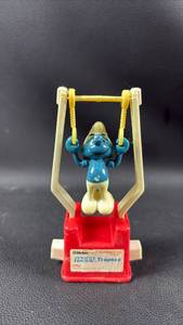 lot 83 image: Vintage Helm Smurf Trapeze Toy Approximately 6 Inches Tall