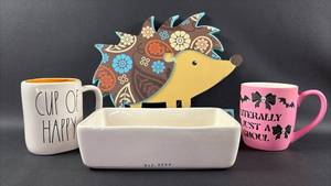 lot 223 image: Rae Dunn Ceramic Baking Dish with Decorative Mugs and Hedgehog Wall Decor