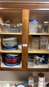 lot 27 image: Kitchen Cabinet Lot Glass Jars, Storage Containers, Measuring Cups, Popcorn Bowl