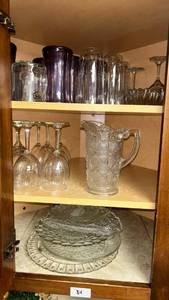 lot 34 image: Glassware Lot Wine Glasses Pitcher Vases Platters (whole cabinet of contents)