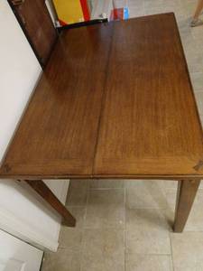 lot 904 image: Bar height wooden table, 36x54x36, plus 18inch leaf, located in basement