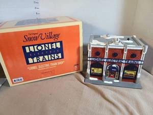 lot 1330 image: Lionel Electric Trains Snow Village Lionel Electric Train Shop Handpainted Ceramic Building