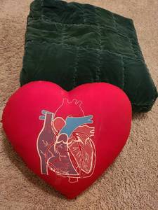 lot 1391 image: Heart pillow and dark green bedspread, worn on underside