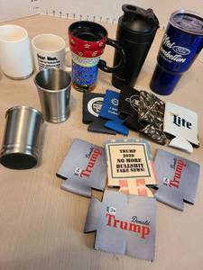 lot 7128 image: Romero Britto ceramic travel mug, Trump koozies, stainless glasses, more