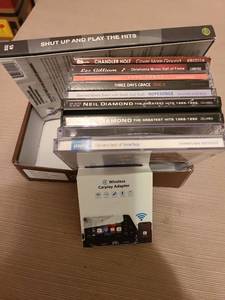 lot 7146 image: CDs, plus wireless car play adapter