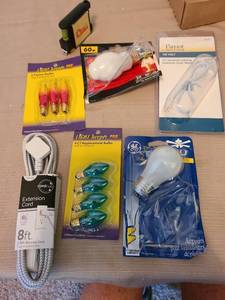 lot 7176 image: Light bulbs, extension cord, measuring tape with level.