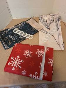 lot 7191 image: 2 shower curtains with rings and a red snowflake vinyl tablecloth.