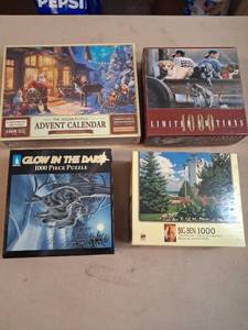 lot 13 image: Lot of 4 Jigsaw Puzzles 1000 Piece Advent Calendar Glow Dark Limited Editions