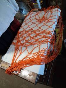 lot 105 image: Orange Knotless Netting with Metal Rings Approximately 48 x 24 inches