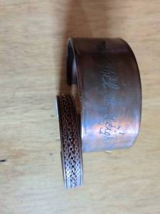 lot 205 image: Two Metal Cuff Bracelets with Handwritten Markings