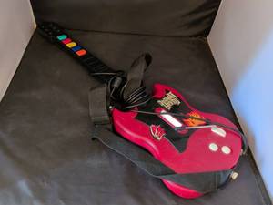 lot 263 image: Red Guitar-Shaped Video Game Controller with Color Reference Card