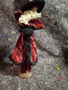 lot 29 image: Doll with Red and Black Outfit, Black Hat, Lace Collar