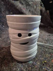 lot 400 image: Mummy Ceramic Candle Holder with Purple Candle