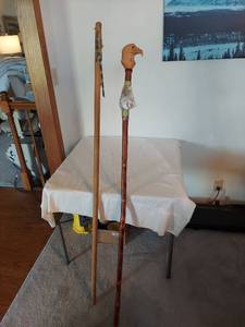 lot 1142 image: Carved Eagle Head Walking Stick and Plain Staff with Beaded Decoration