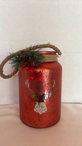 lot 1055 image: Red Metallic Jar Candle Holder with Rope Handle and Evergreen Decoration
