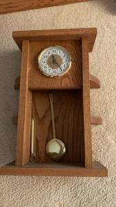 lot 1135 image: Oak Wood Wall Clock with Pendulum and Brass Accents