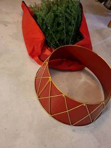 lot 2047 image: Artificial Christmas tree in storage bag, plus a red and gold metal drum Christmas tree collar