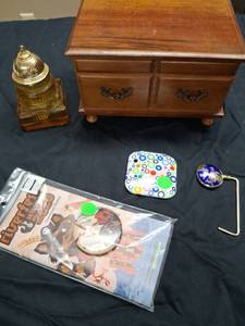 lot 67 image: Mixed Lot Musical Jewelry Box, Compact Mirror, Handbag Table Hook and Riverfest 2010 Program Pin.