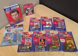 lot 80 image: Jeff Gordon Lot Racing Memorabilia - Cars w cards new in package, Hallmark Ornament, figurine and a book