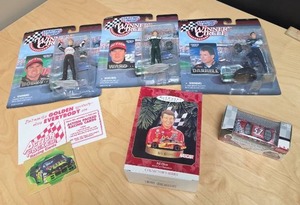 lot 81 image: Starting Lineup Winners Circle NASCAR Action Figures (qty 3), Hallmark Bill Elliot ornament, gold foil racing card, and #57 die-cast car