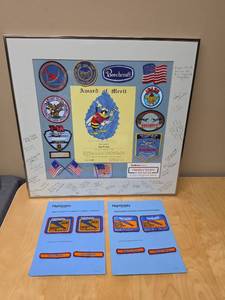 lot 103 image: Beechcraft Award of Merit Patches in frame (personal award - could open and remove patches) and flight safety program patches