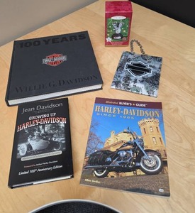 lot 104 image: Harley Davidson collectibles - 100 Years Book, Signed Copy of Jean Davidsons Growing Up Harley-Davidson, Buyers Guide Magazine, small gift bag and a Harley engine Hallmark Ornament