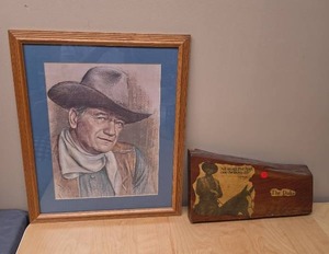 lot 111 image: Framed John Wayne Pencil Drawing Print and a The Duke Wood hangable wall art with the paper glazed into the wood (has a chip on upper corner)