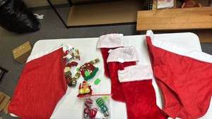 lot 224 image: Christmas Holiday Decoration Lot - Red Stockings, 2 large hats (use as bags), red and green light bulbs, ornaments and Reindeer tea light holder