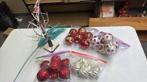 lot 233 image: Christmas Ornaments - silver and red, and a small tree with snow frosted branches