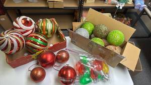 lot 238 image: Two boxes of Extra Large Christmas Ornaments (hang from tree in the yard), solar light bulb shaped lights, and some other Christmas lightsls Bows Glitter