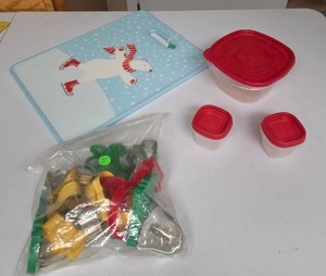 lot 818 image: Food storage containers, Polar Bear cutting board, and cookie cutters