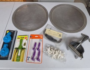 lot 841 image: Two pizza pans, kitchen gadgets, vintage meat press, brand new Pampered Chef veggie chopper