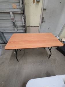 lot 308 image: Folding 4 Foot Table with Wood Grain Top and Black Metal Frame 48 W x 24 18 D x 29.5 H