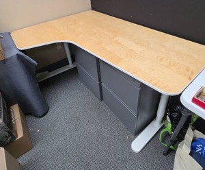 lot 312 image: L-Shaped Corner Desk - Blonde Wood top and White Metal Base (filing cabinets under not included, see other lots). 63 W x 28.5 H.  Wide part is 43 38D narrow 25.5 D