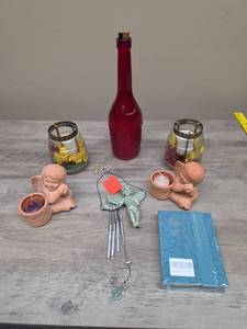 lot 335 image: Home Decor Lot Red Bottle, Glass Tea Light Vases with floral accents, Terra Cotta Angel Votive Holders, Cherub Wind Chime, and fragrance flakes